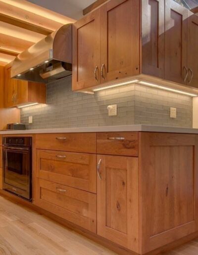 Modern kitchen interior with wooden cabinets, stainless steel appliances, and a subway tile backsplash.